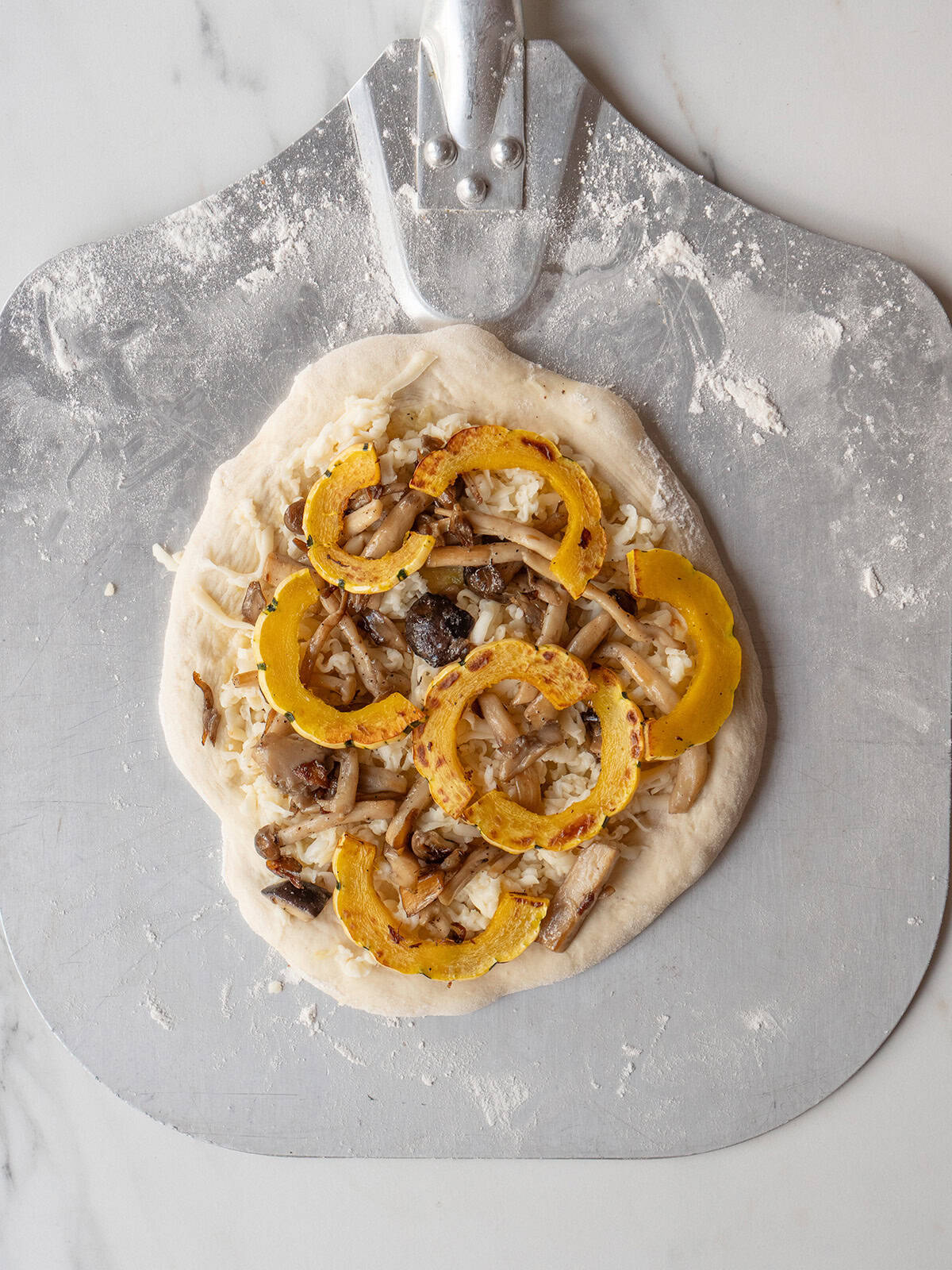 Pizza dough with squash and mushrooms