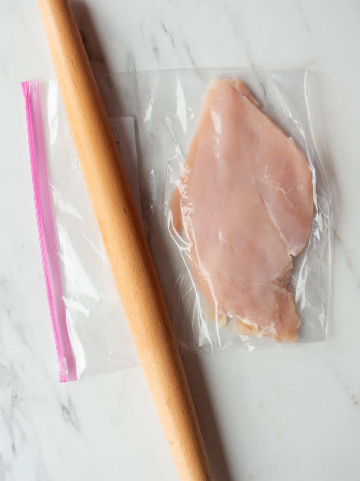 Raw chicken breast in plastic bag