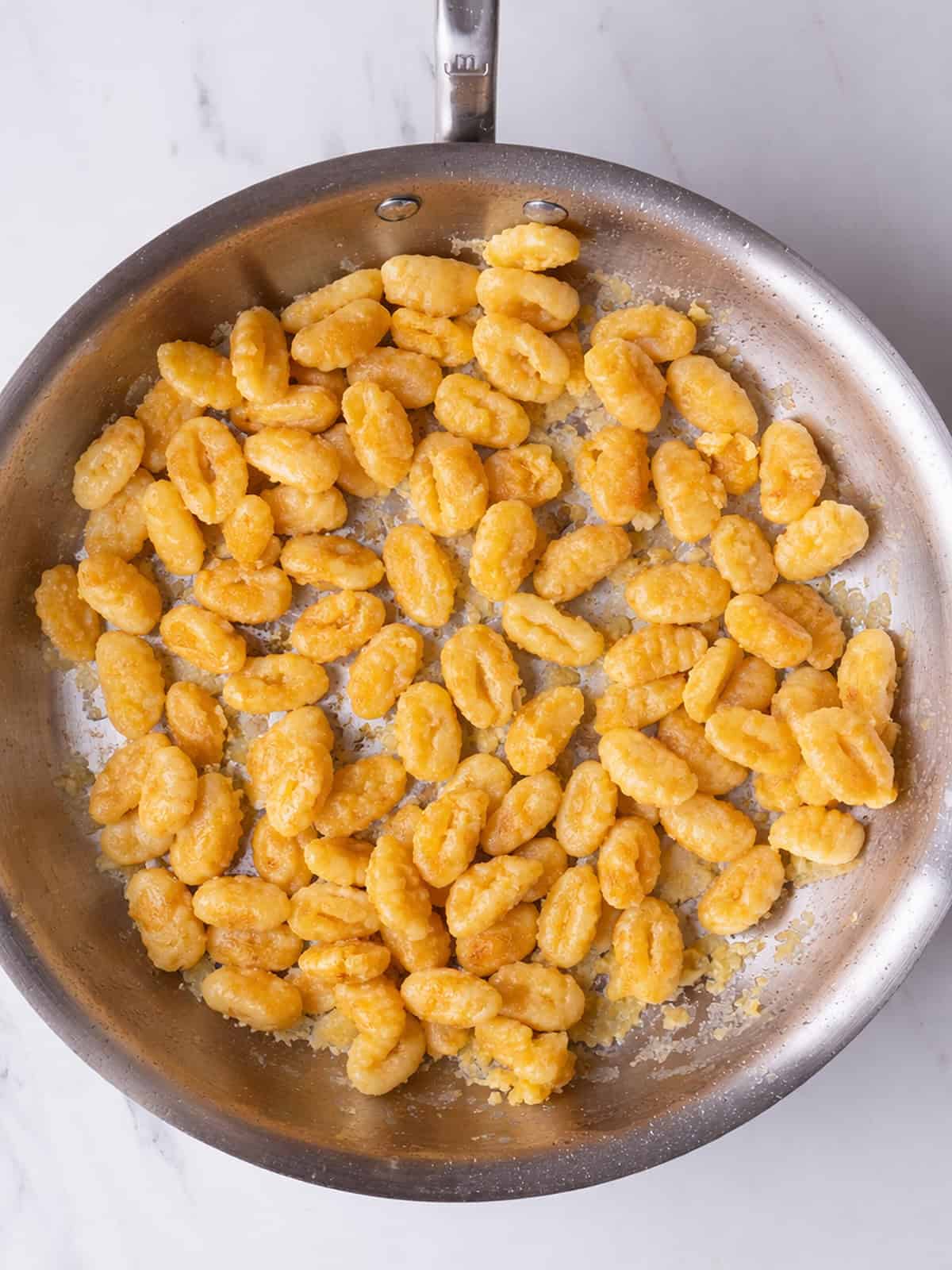 Golden gnocchi in a skillet