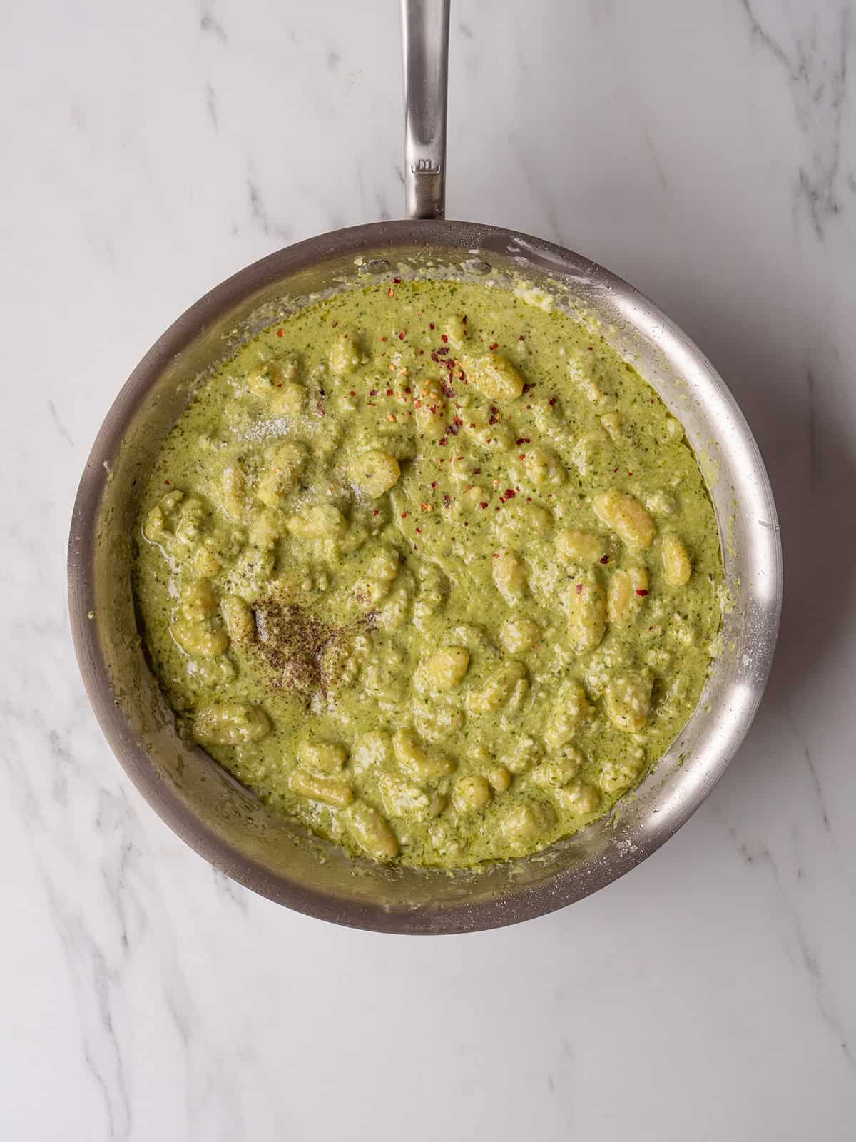 Creamy pesto gnocchi in skillet