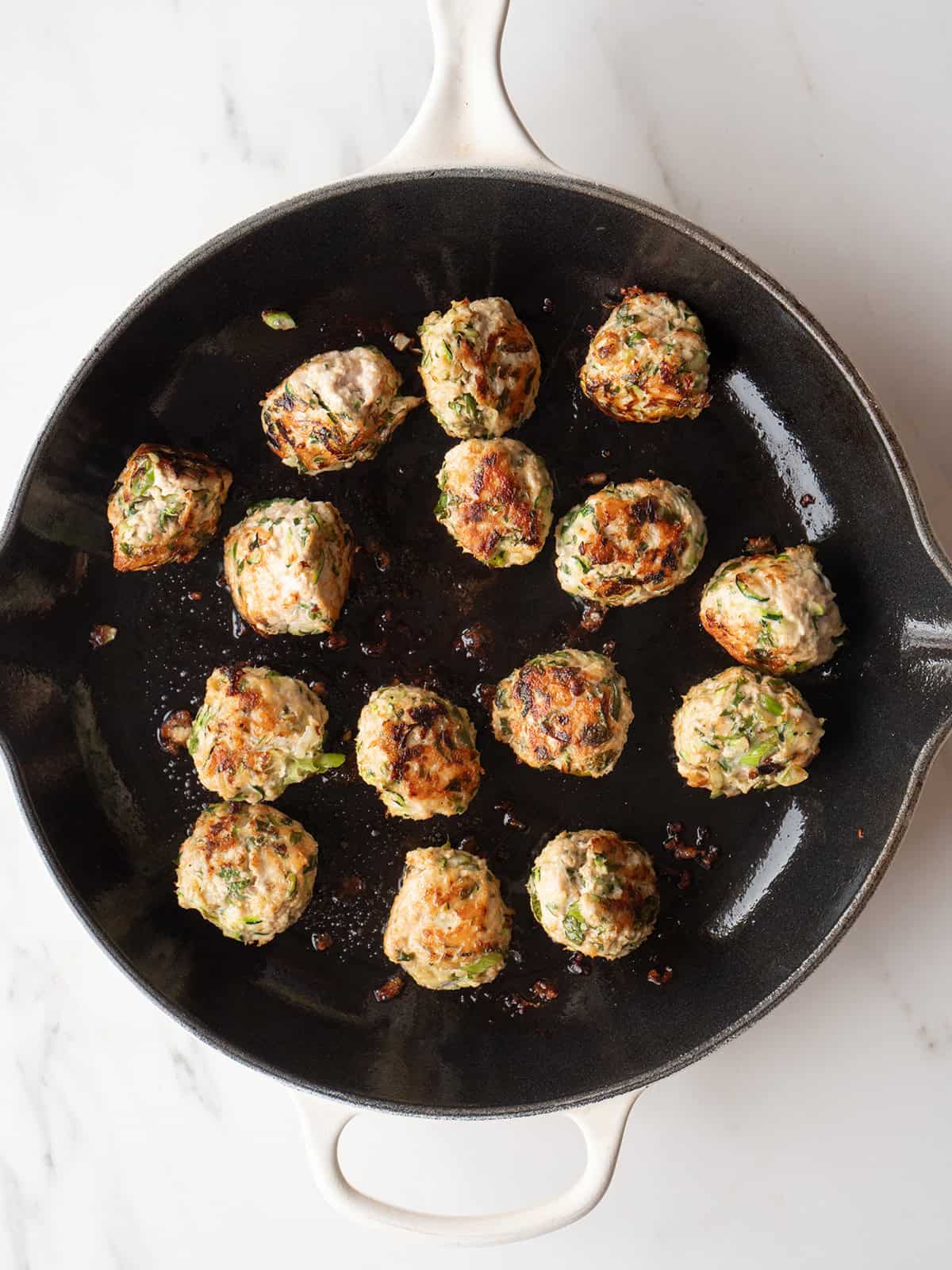 Cooked meatballs in a skillet