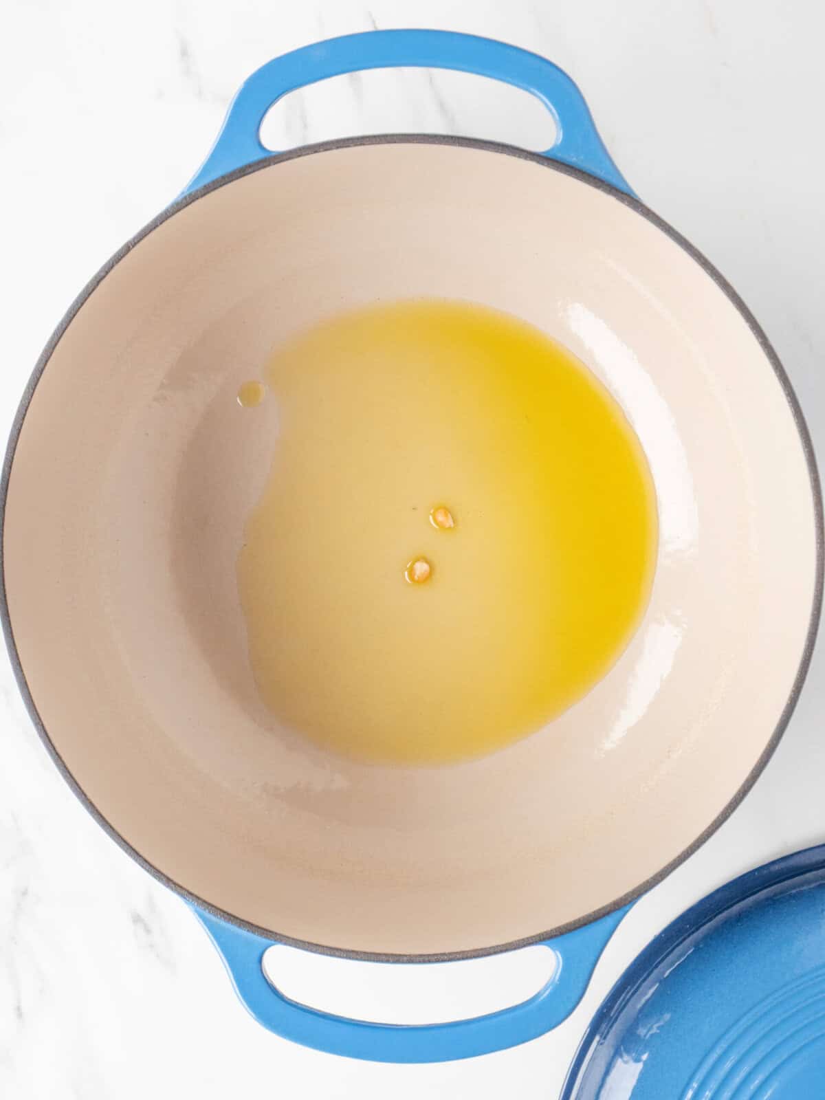 Oil in a cooking pot with corn kernels
