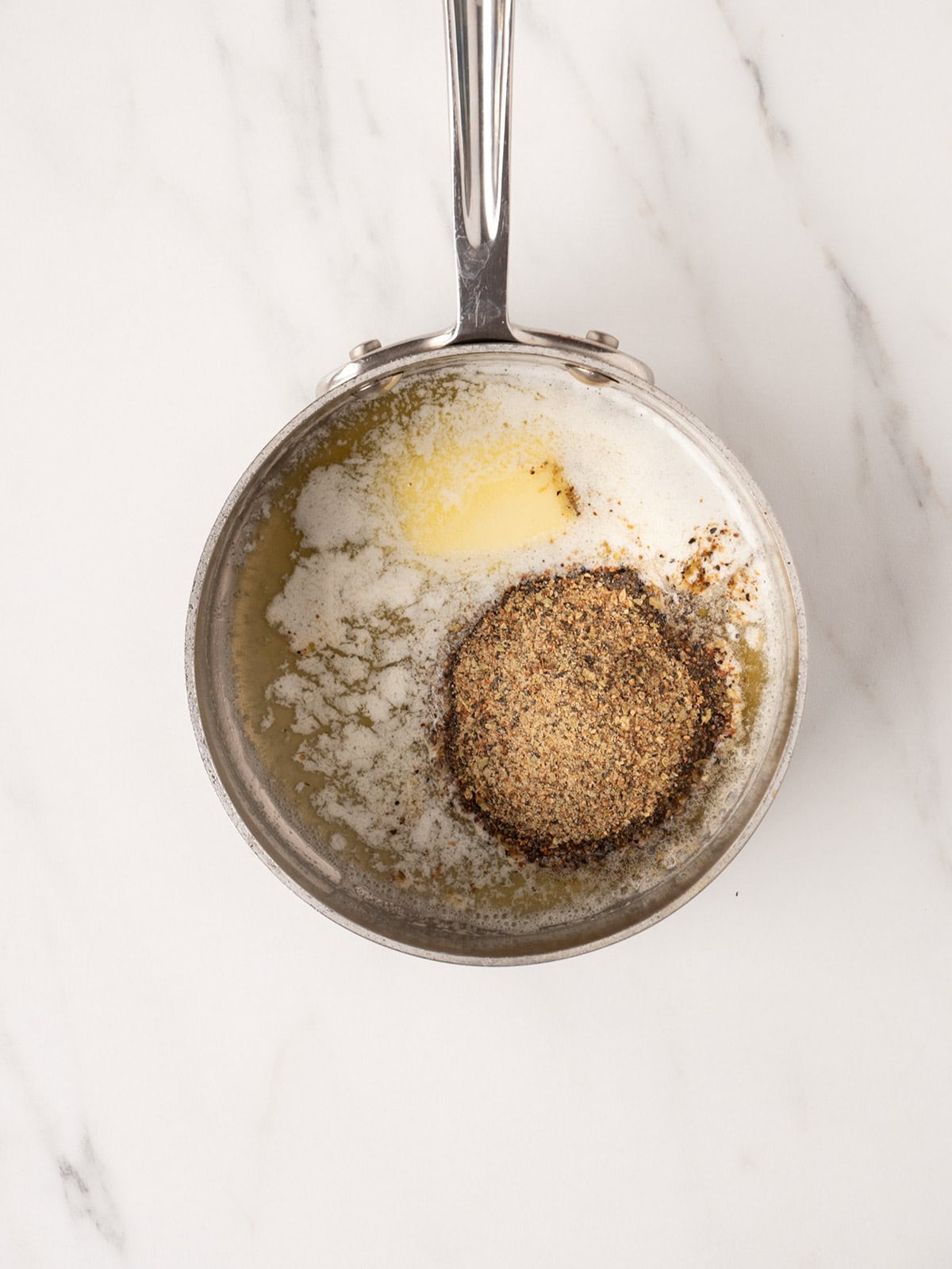 Melted butter with seasoning in pan