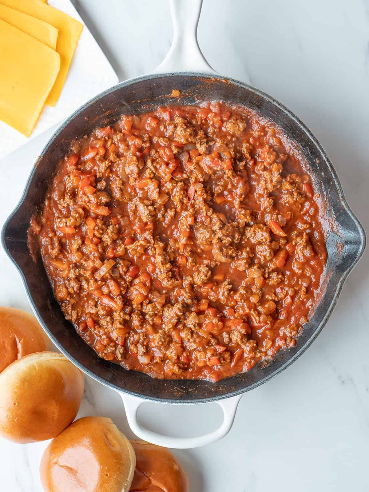 Sloppy Joe mixture with buns nearby