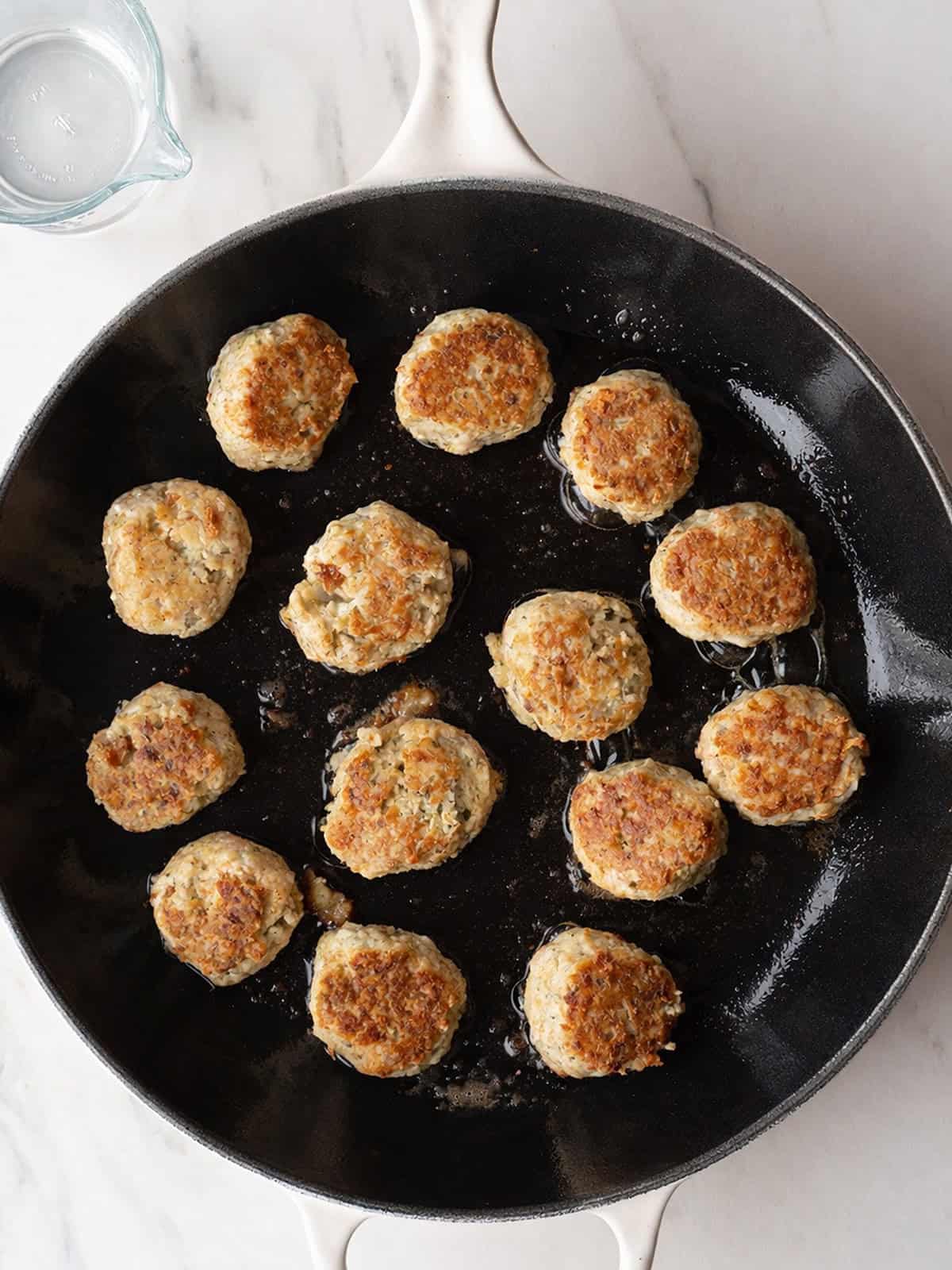 Golden brown meatballs in skillet