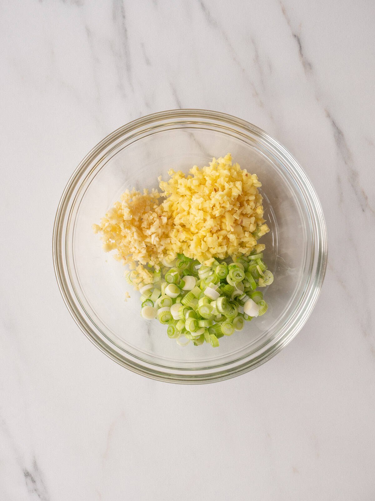 Chopped ginger, garlic, and green onions in bowl
