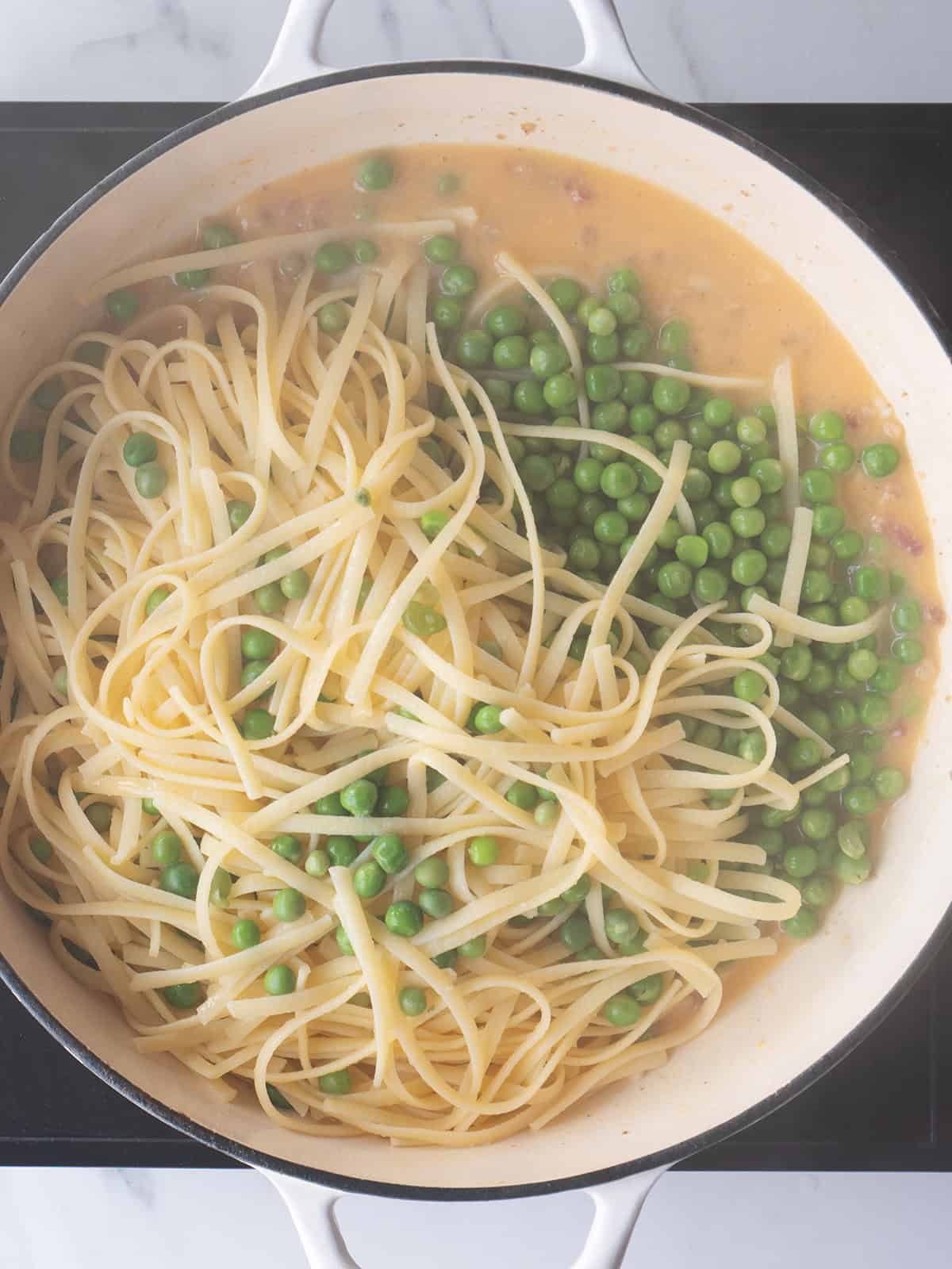 Pasta and green peas in pan