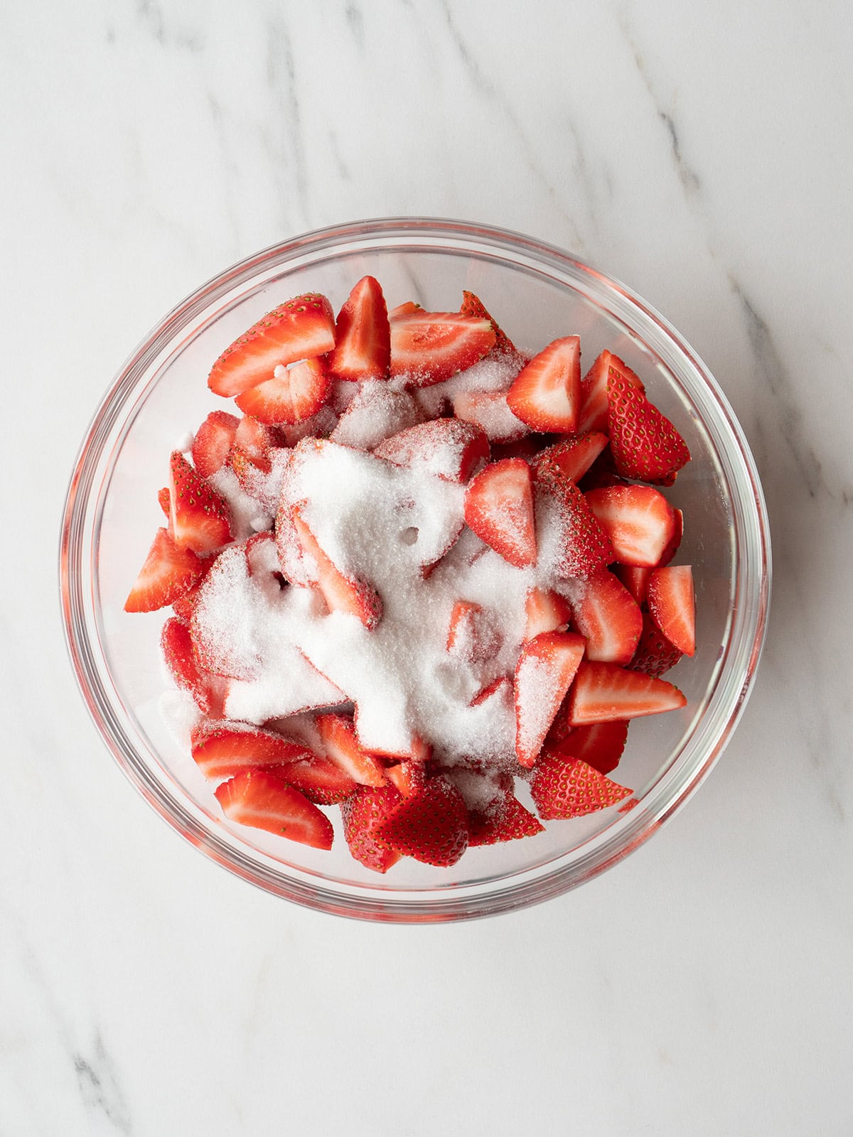 Sliced strawberries with sugar in bowl