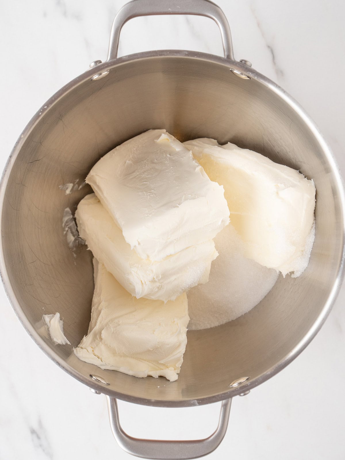 Cream cheese and sugar in mixing bowl