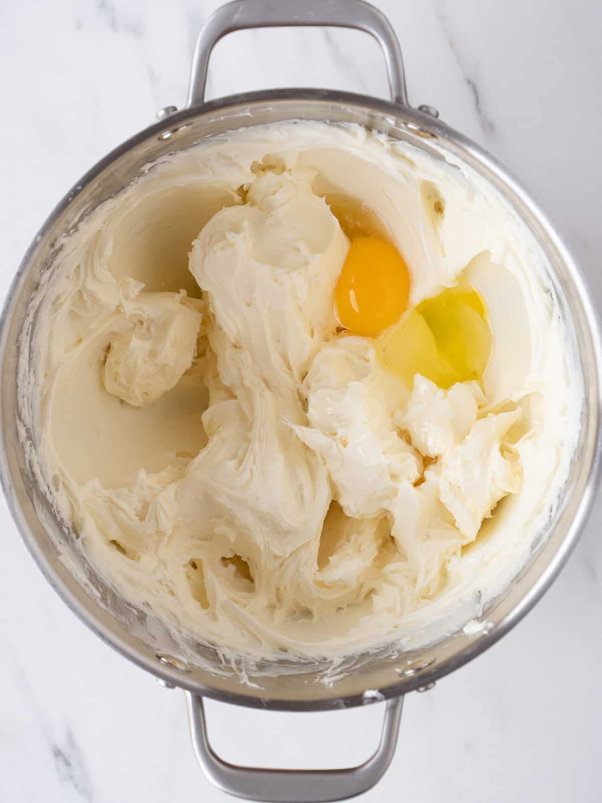 Mixing cream cheese and eggs together