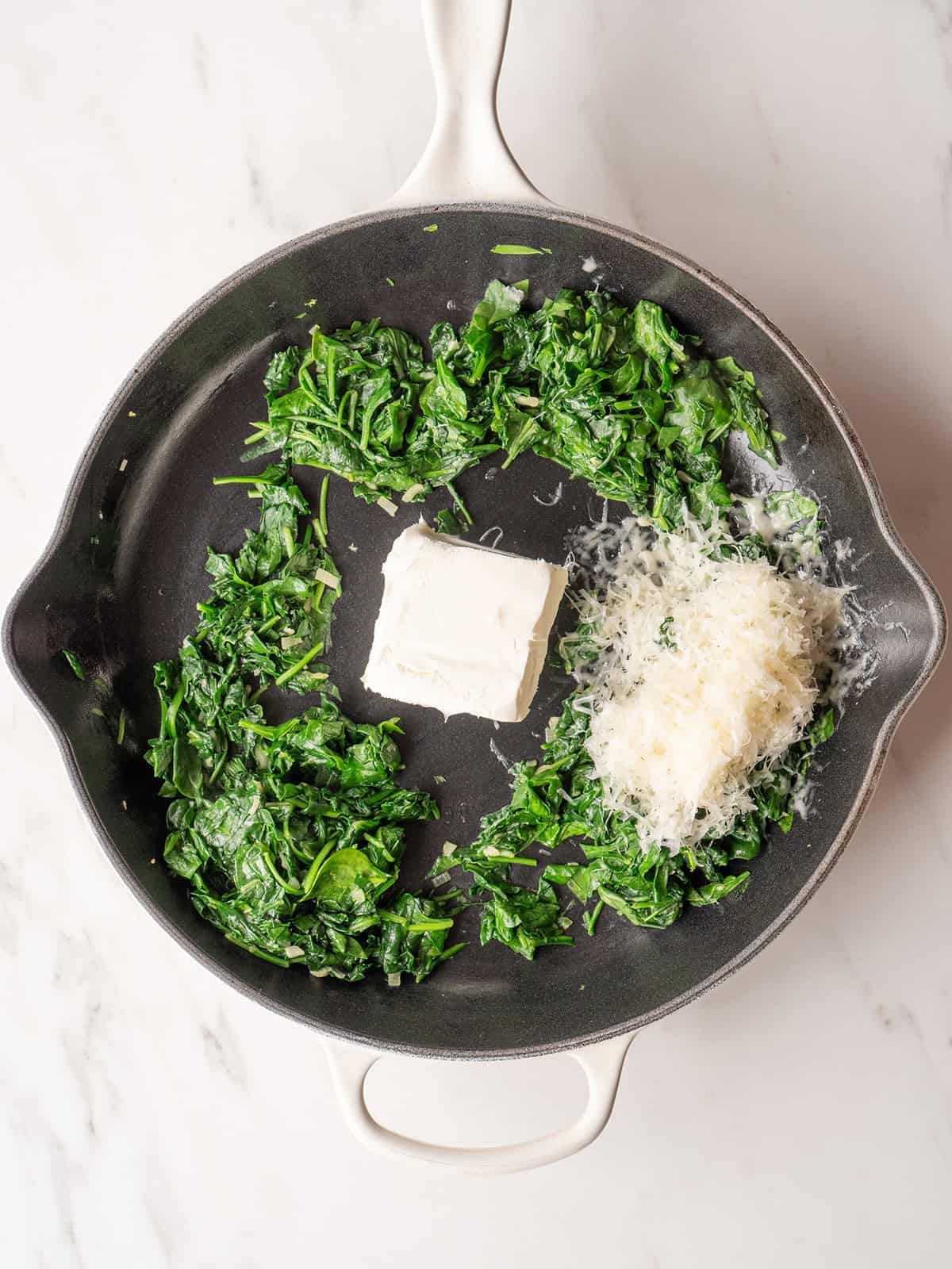 Spinach, cream cheese, and parmesan in skillet