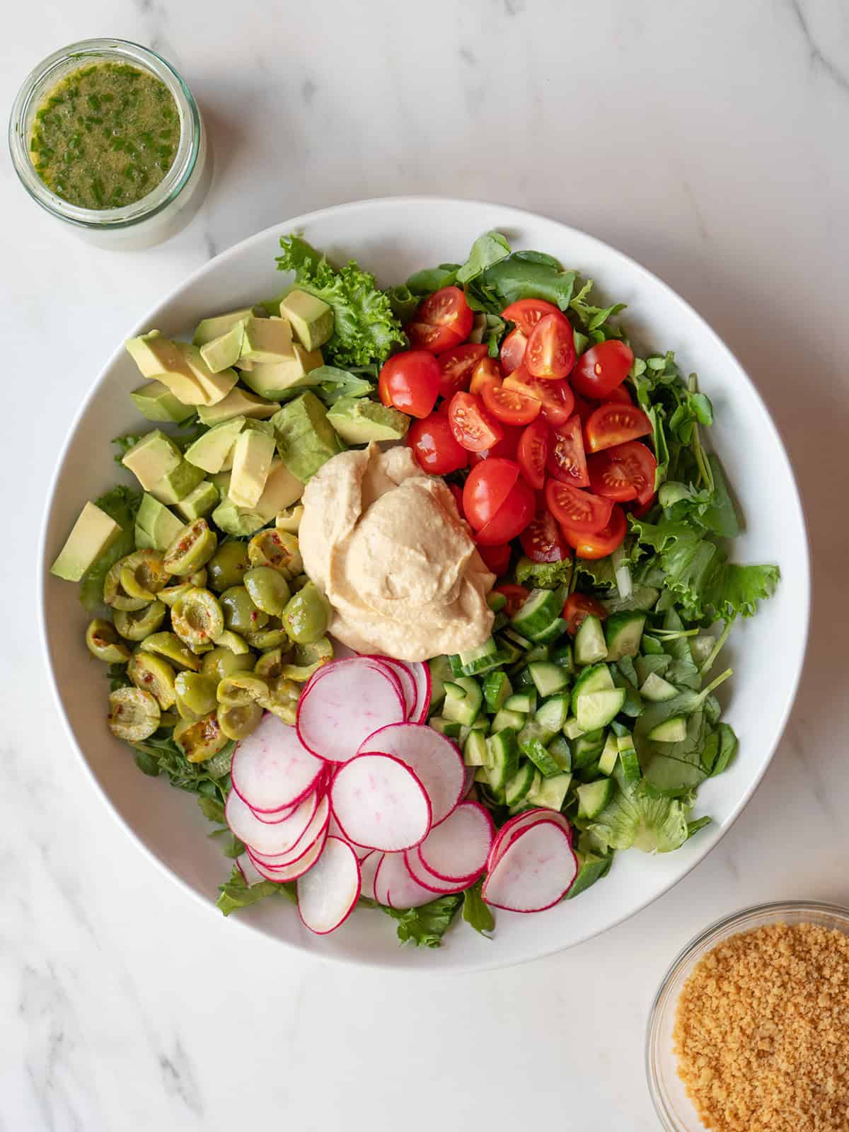 Colorful salad with hummus and vegetables