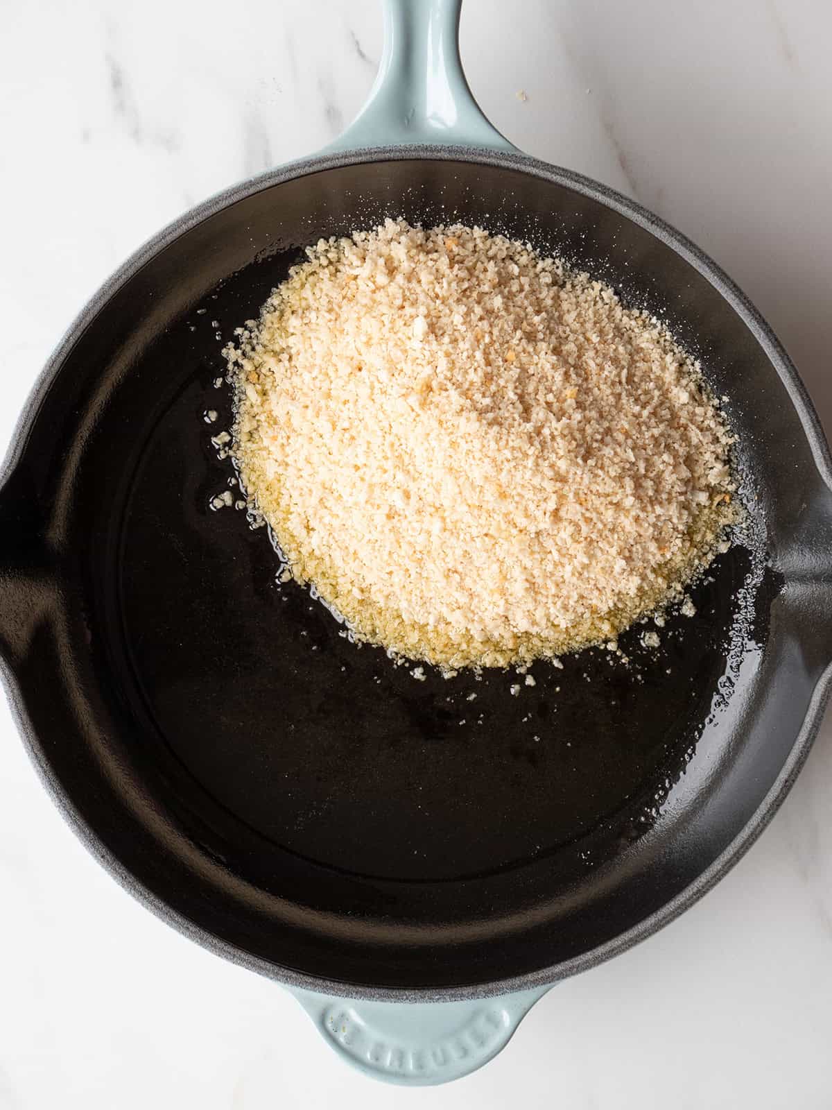 Breadcrumbs in a skillet with oil