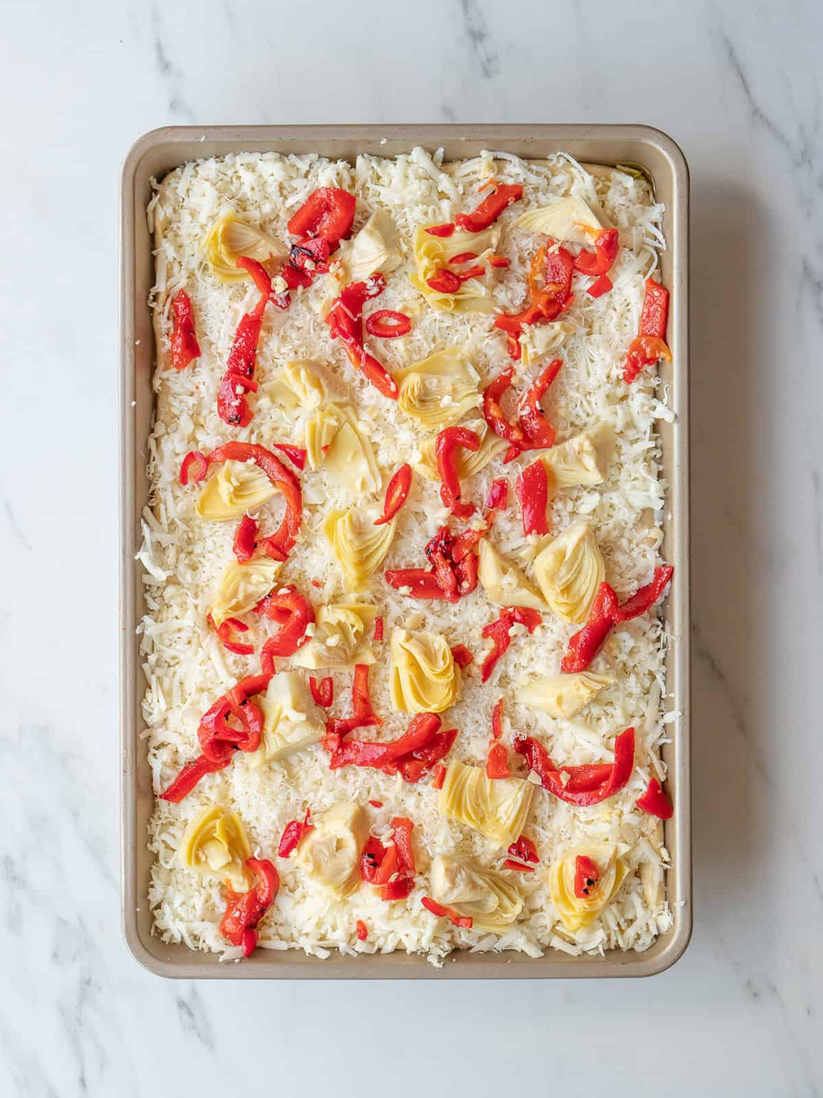 Pizza topped with artichokes and peppers