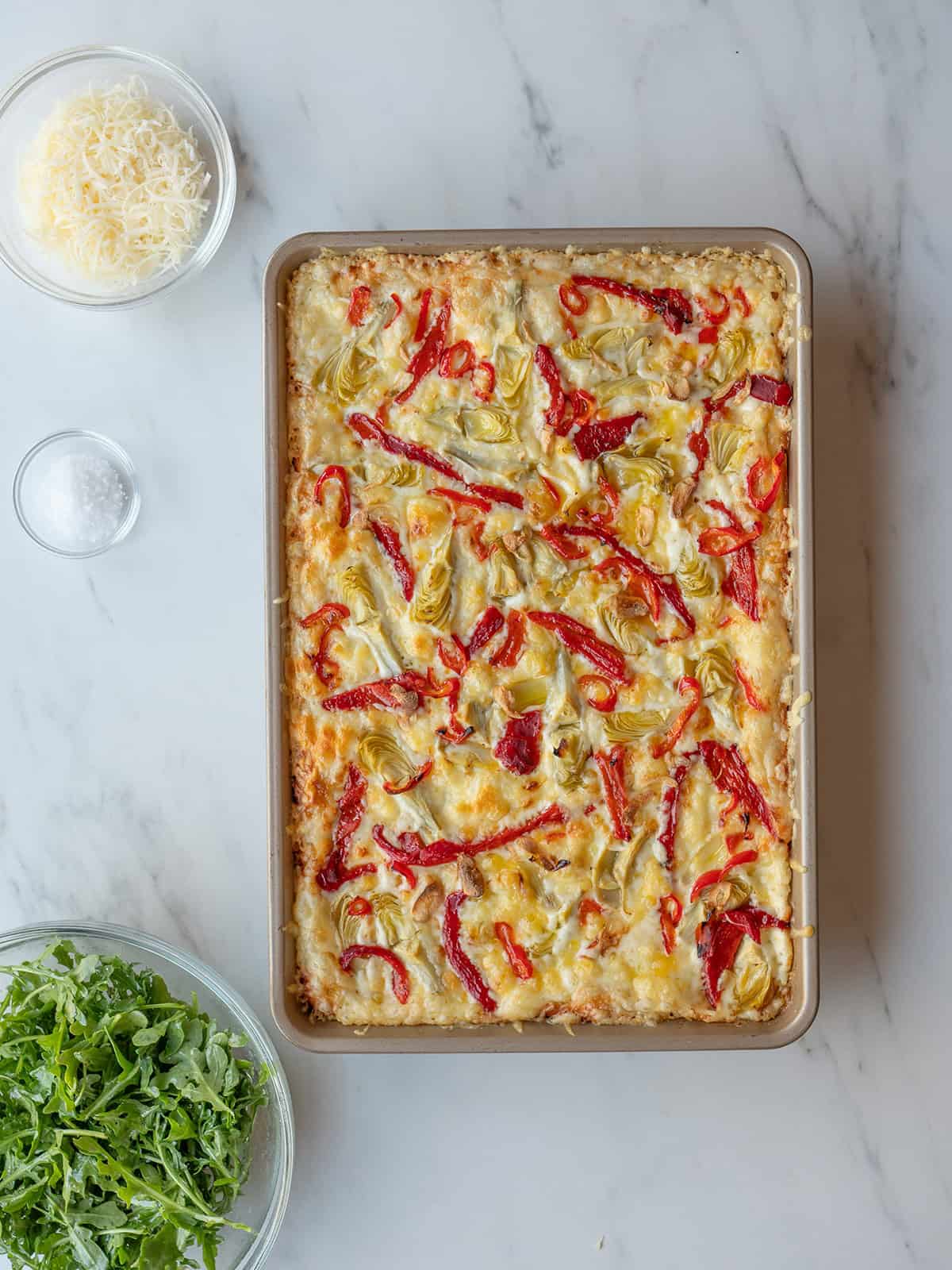Pizza topped with artichokes and peppers