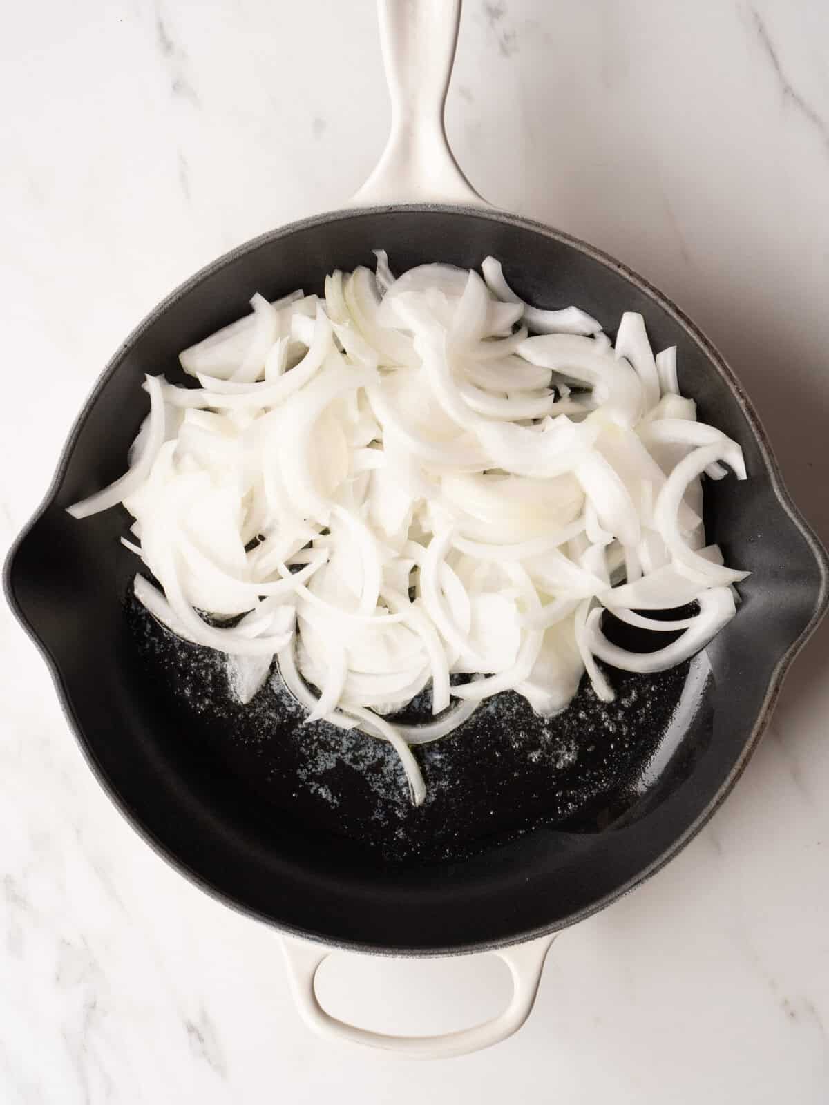 Sliced onions in a skillet.