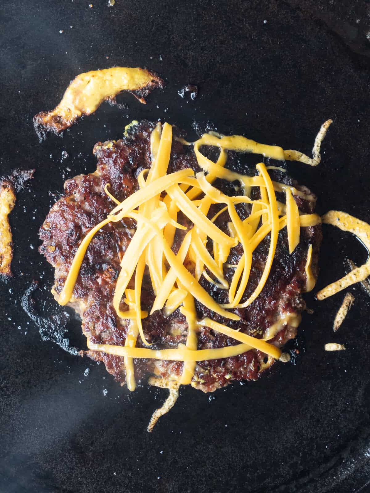 Charred burger with melted cheese