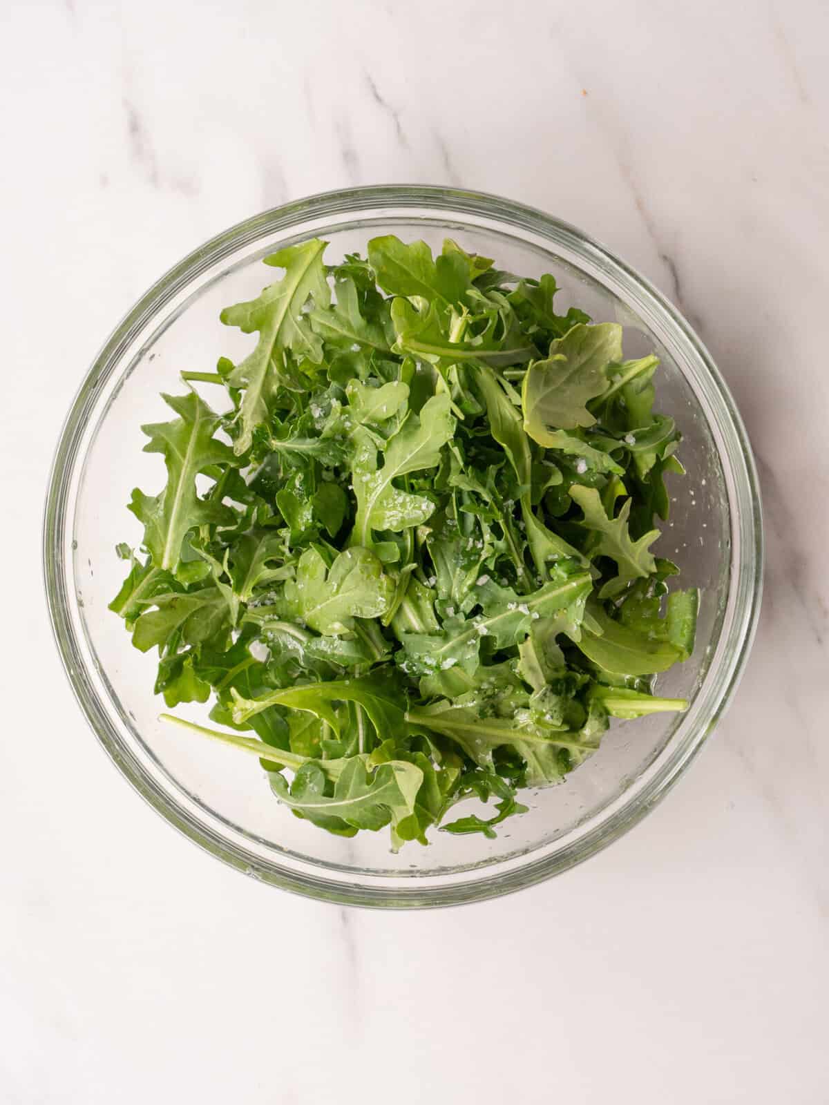Fresh green salad in glass bowl
