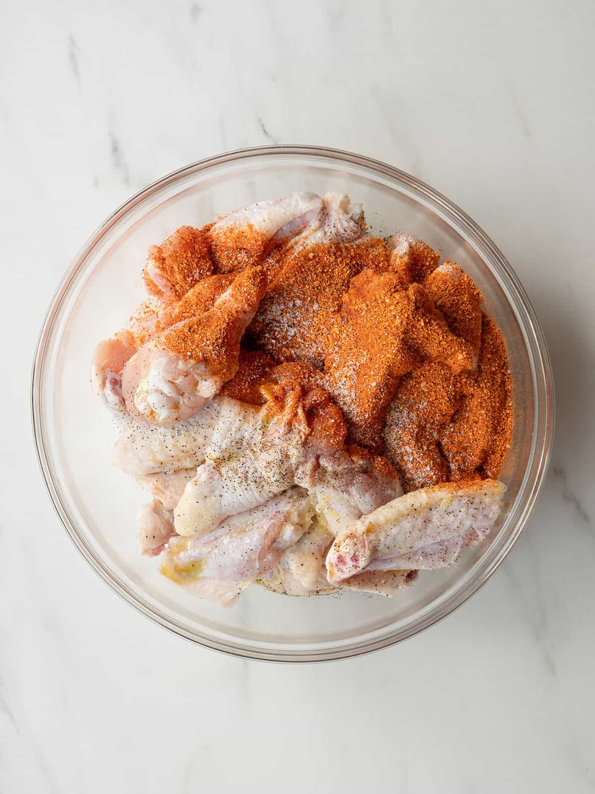 Raw chicken wings with seasoning