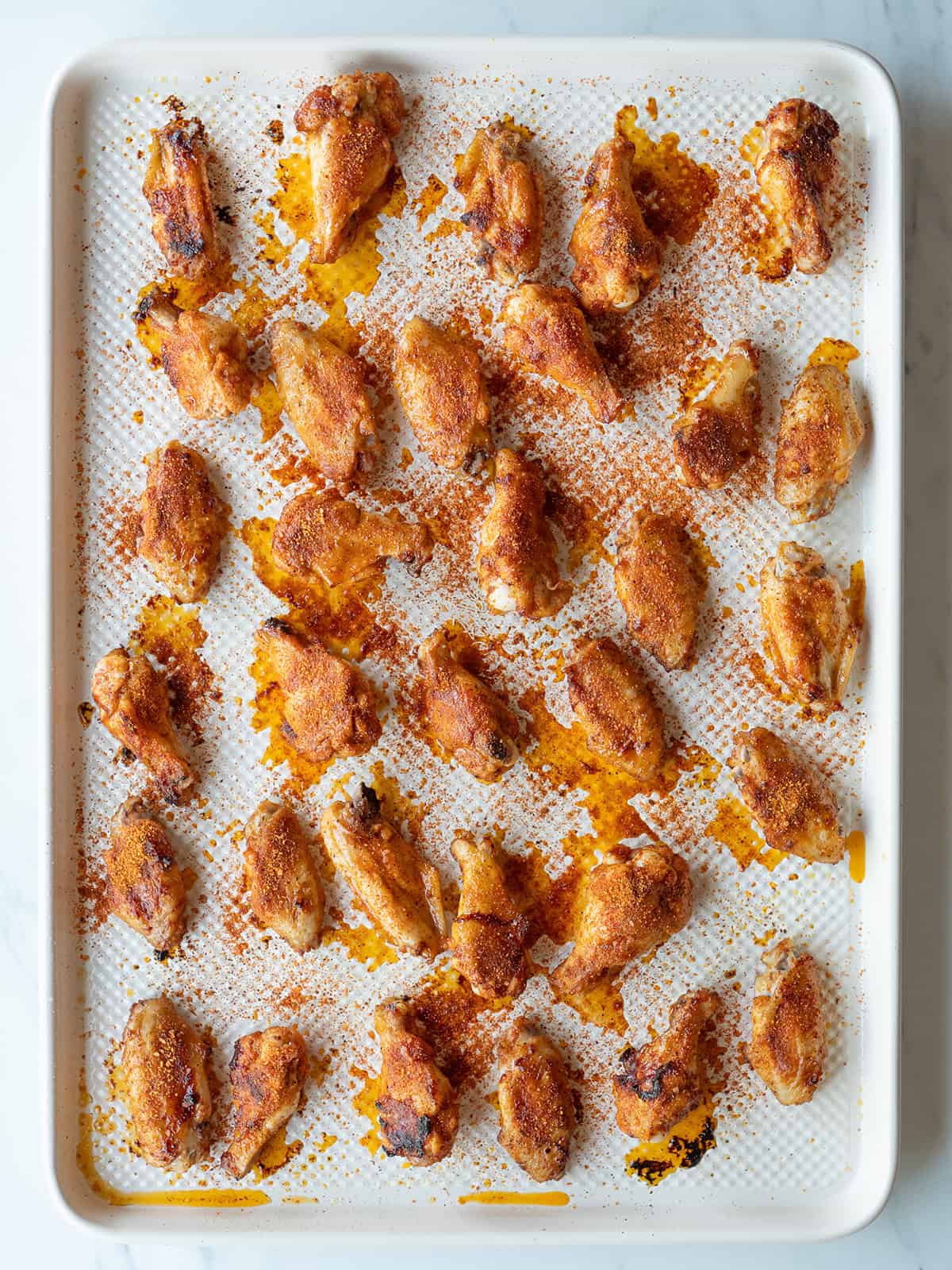 Crispy baked chicken wings on tray