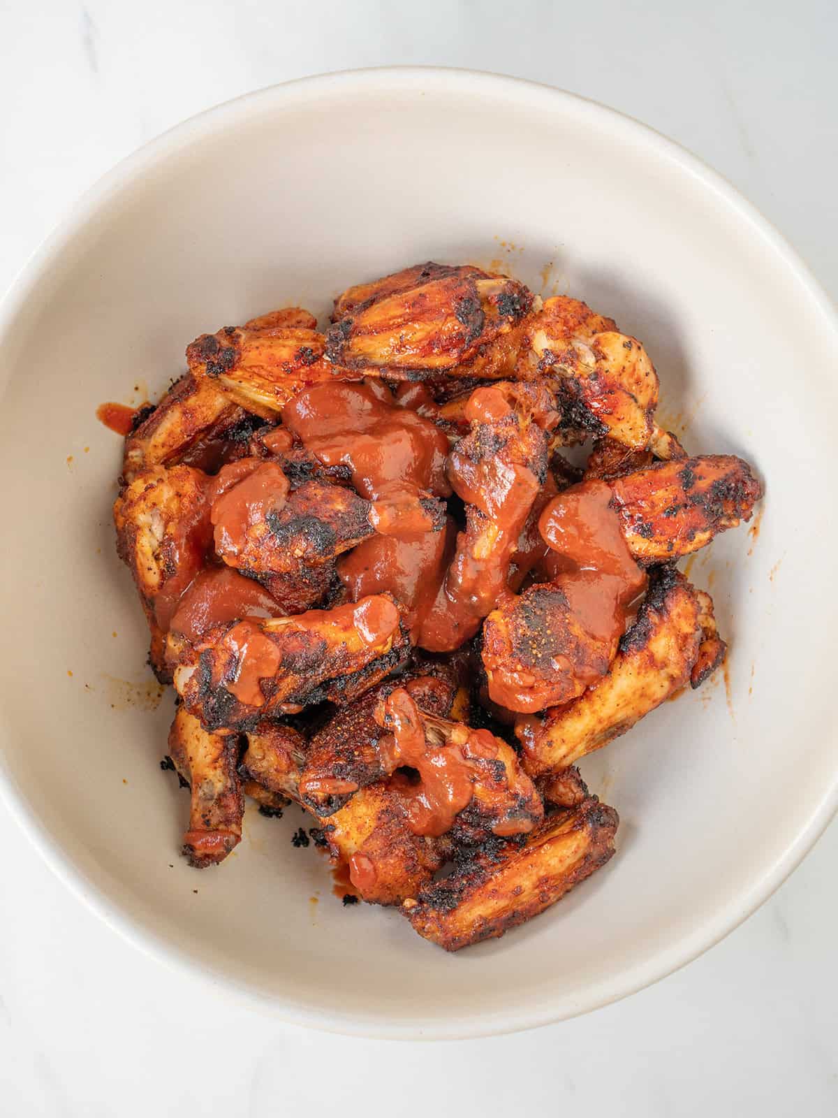 Bowl of saucy BBQ chicken wings