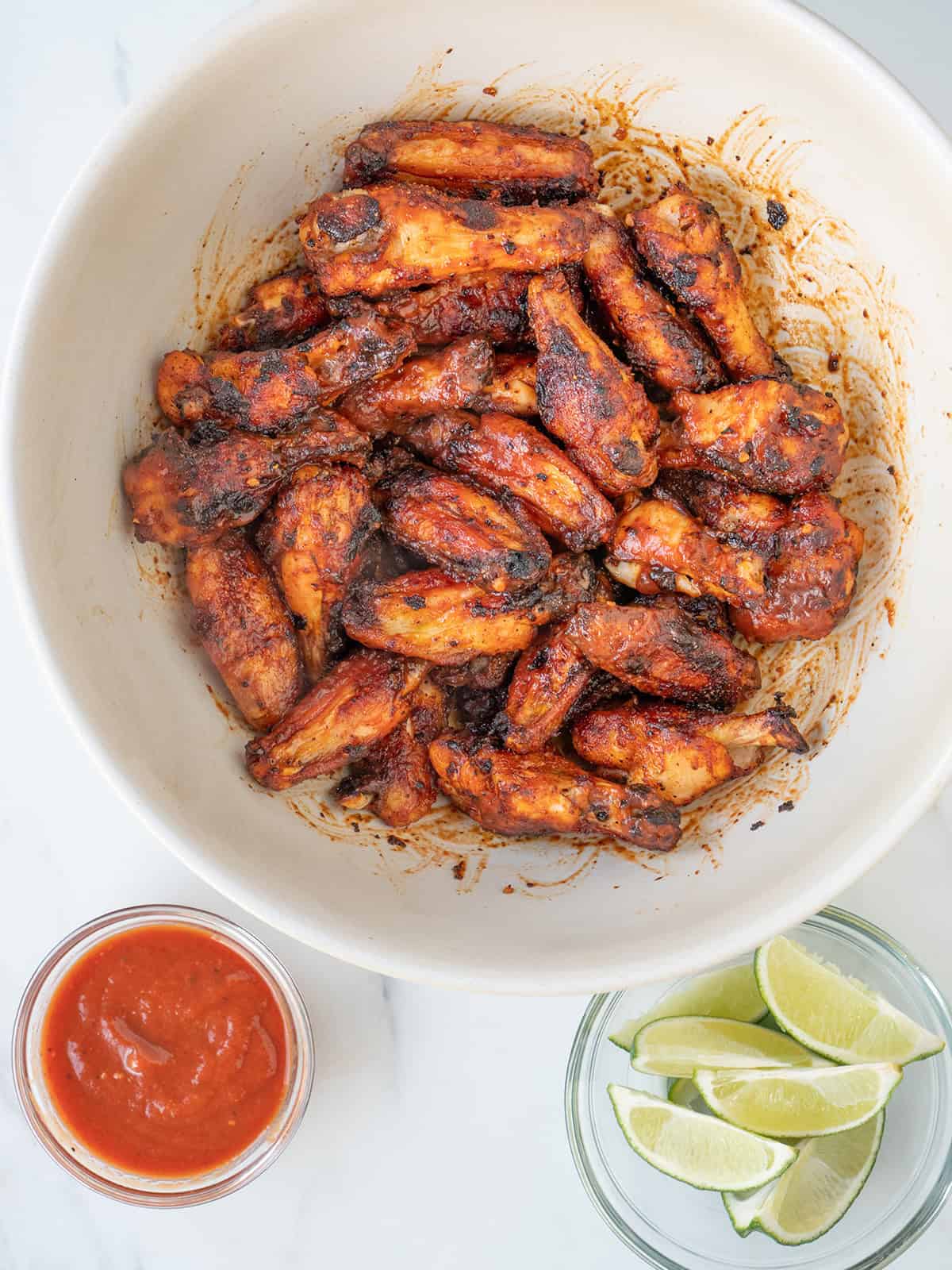 BBQ Wings tossed in smoky BBQ sauce and served with fresh lime wedges