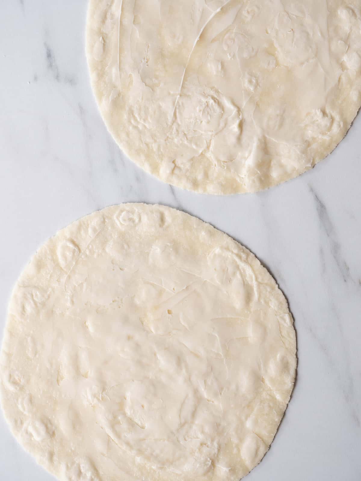 Two tortillas with butter on top