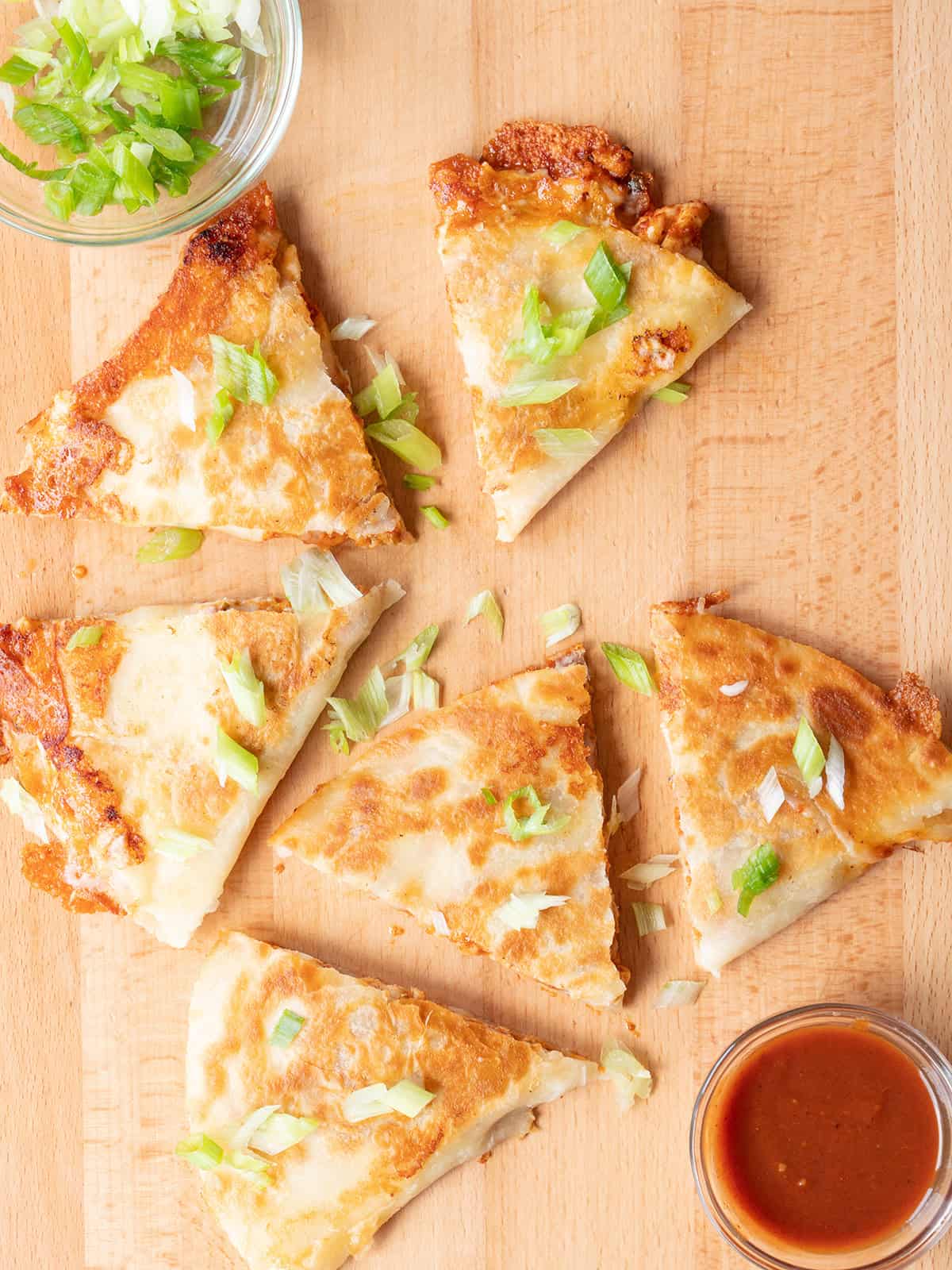 Cheesy BBQ Chicken Quesadillas topped with scallions