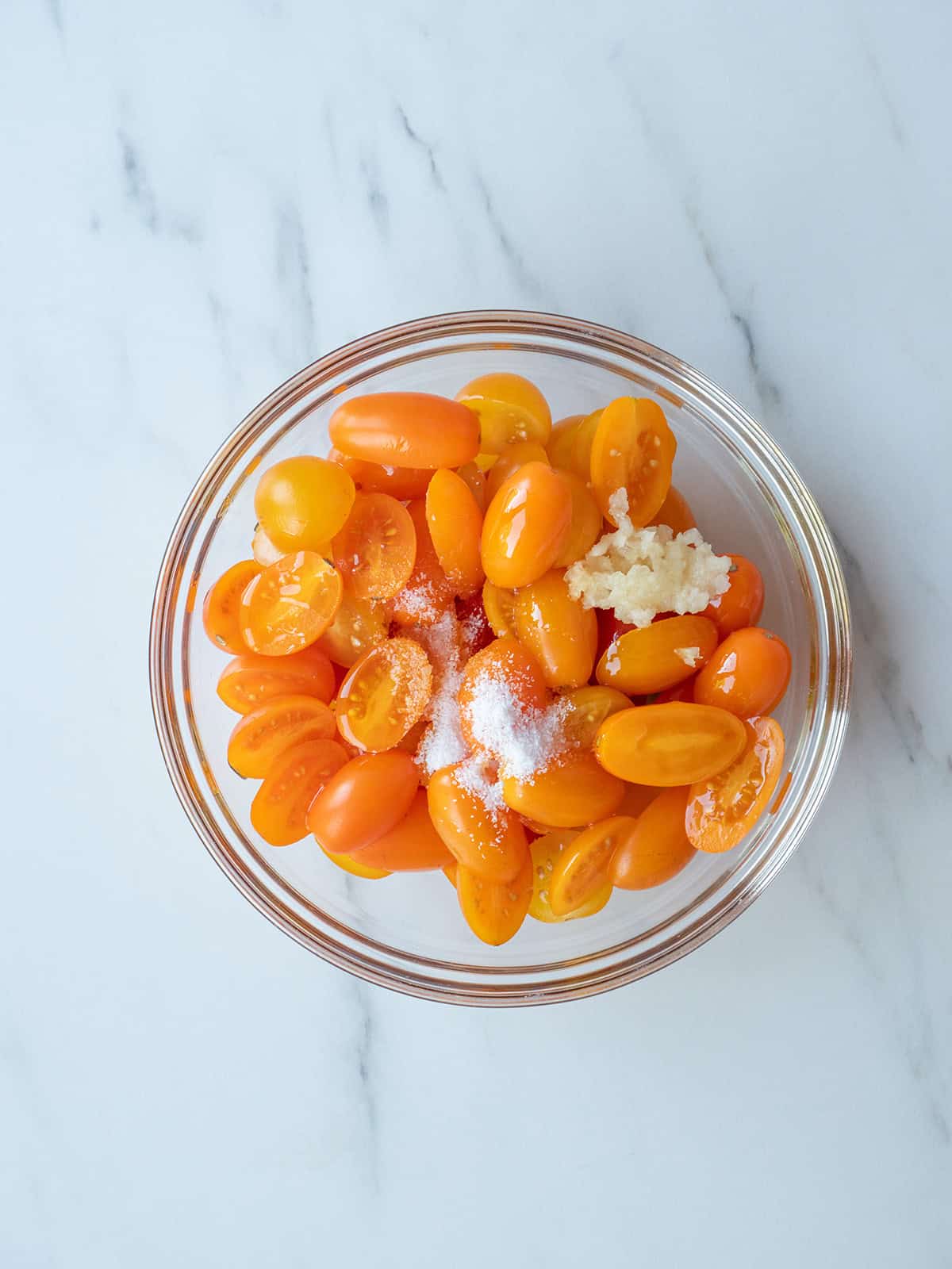 Yellow tomatoes with garlic and salt