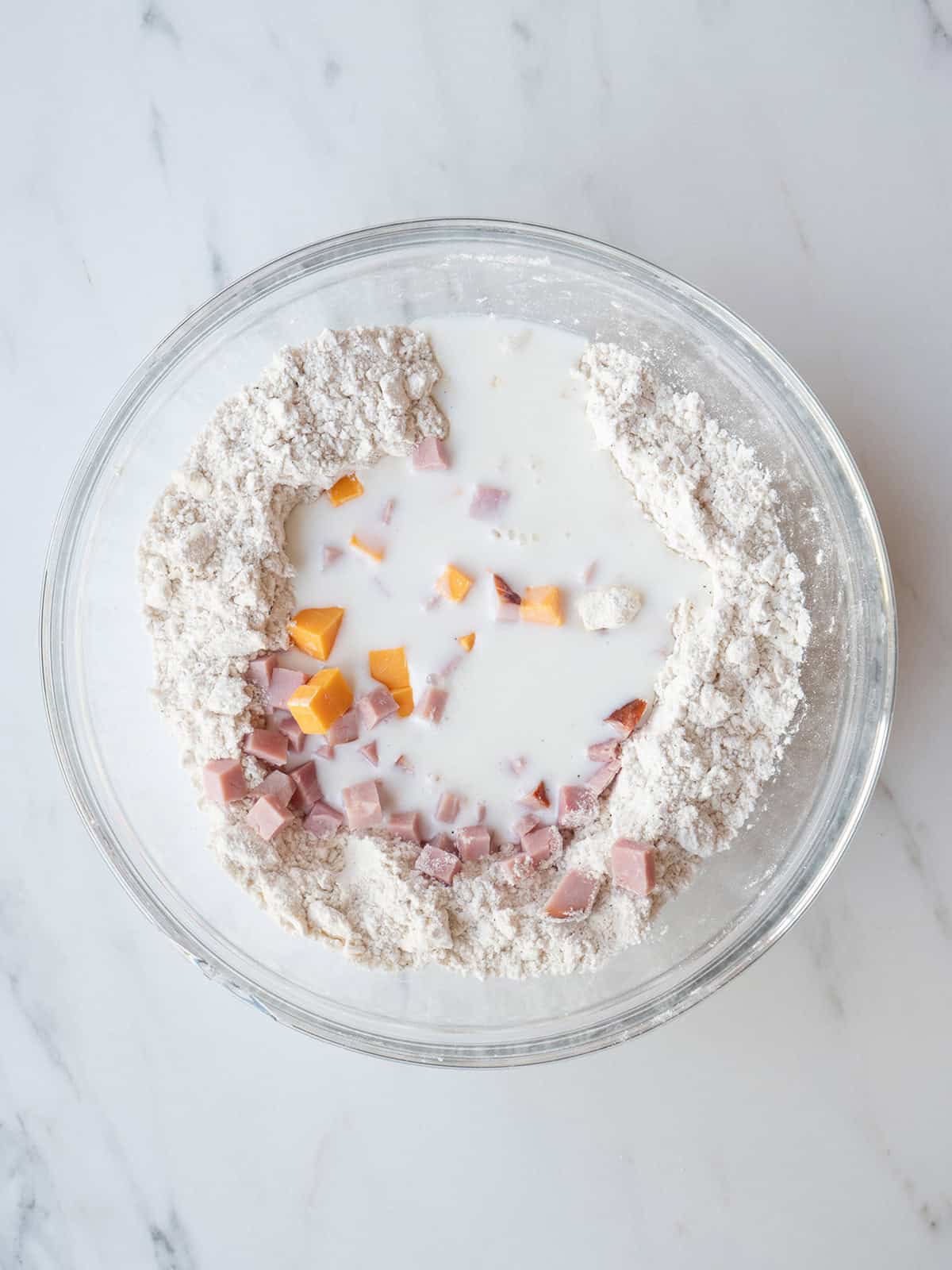 Bowl of flour, buttermilk, cheese, and ham