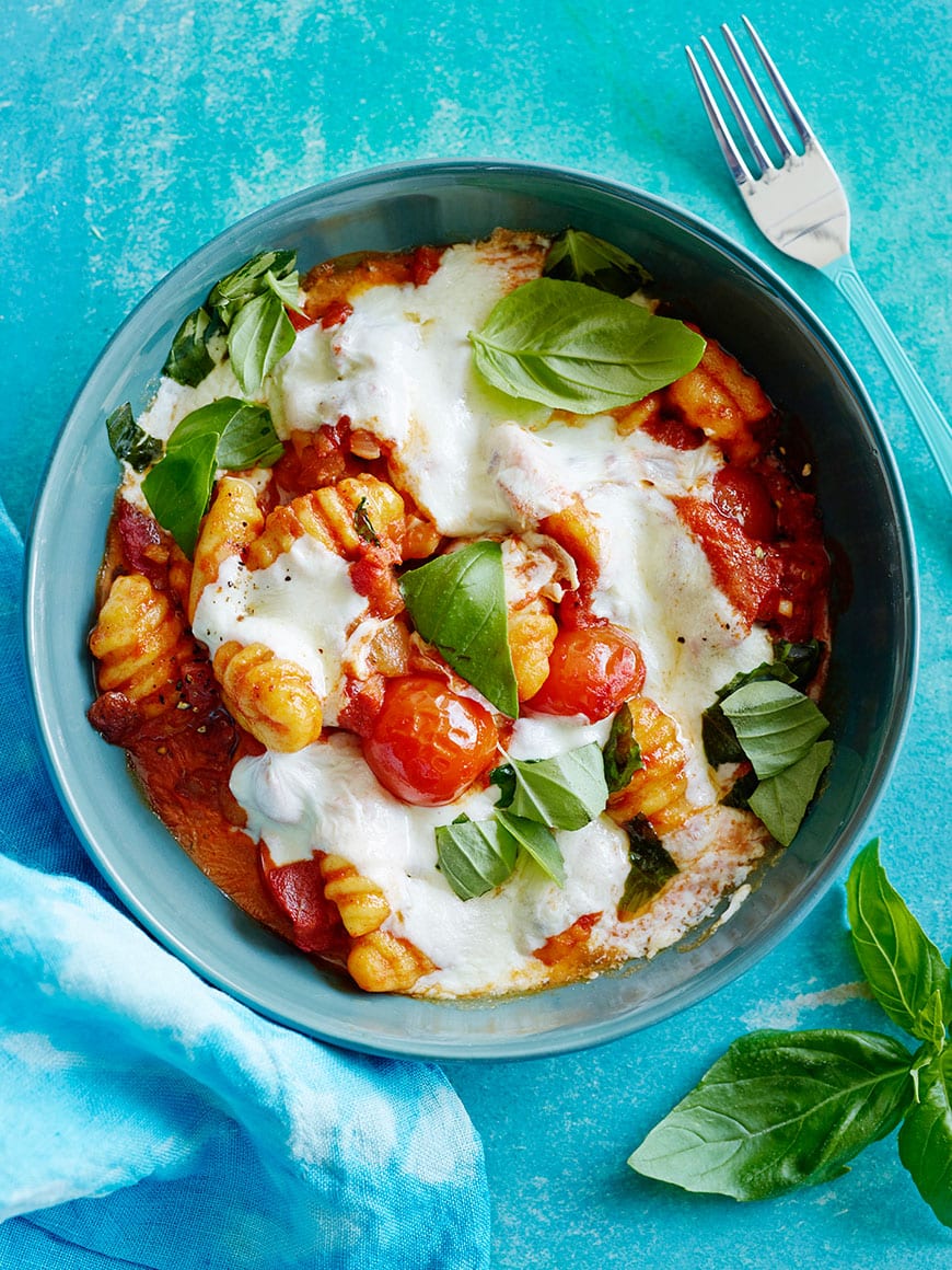 The MOST delicious Cheesy Baked Gnocchi with a pancetta tomato sauce, fresh mozzarella cheese and basil to boot! 